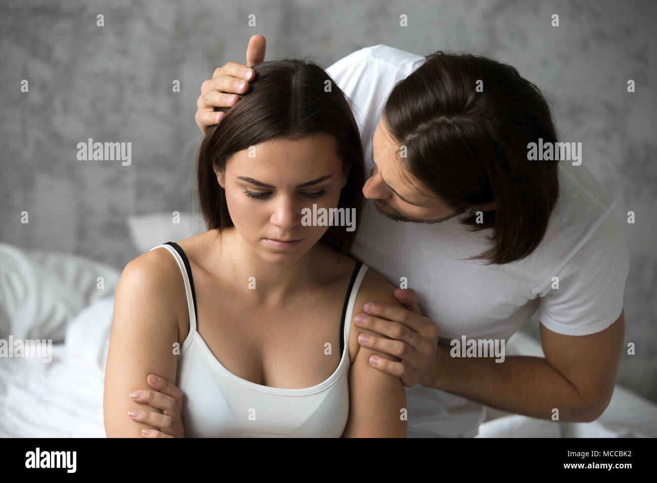 Loving man apologizing resentful sulky woman feeling offended after conflict, boyfriend asking upset capricious girlfriend for forgiveness excusing to Stock Photo