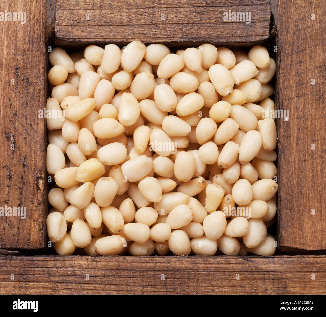 Pine nuts in wooden box. Top view Stock Photo