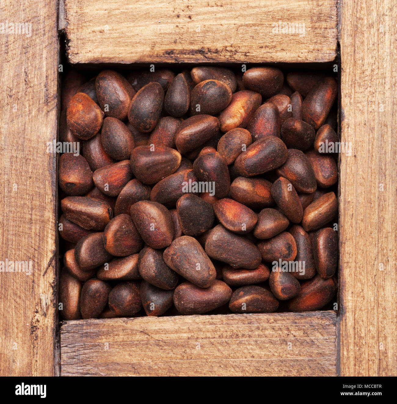 Pine nuts in wooden box. Top view Stock Photo