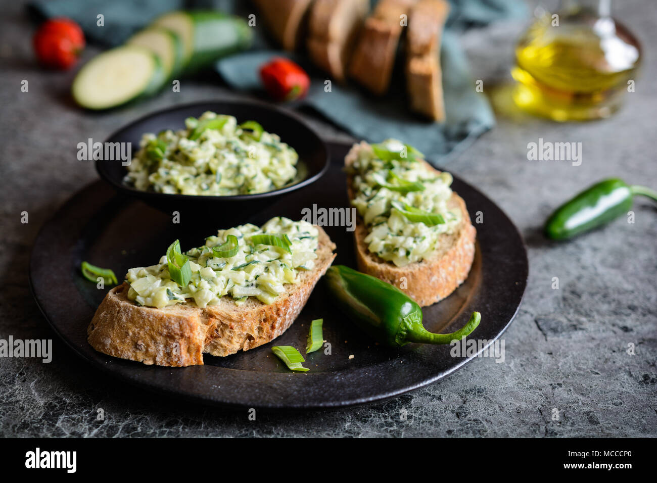 Healthy vegetarian spread made of zucchini, green onion, garlic and cream cheese Stock Photo