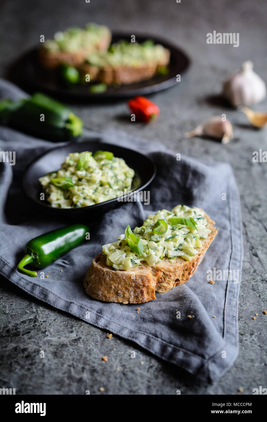 Healthy vegetarian spread made of zucchini, green onion, garlic and cream cheese Stock Photo