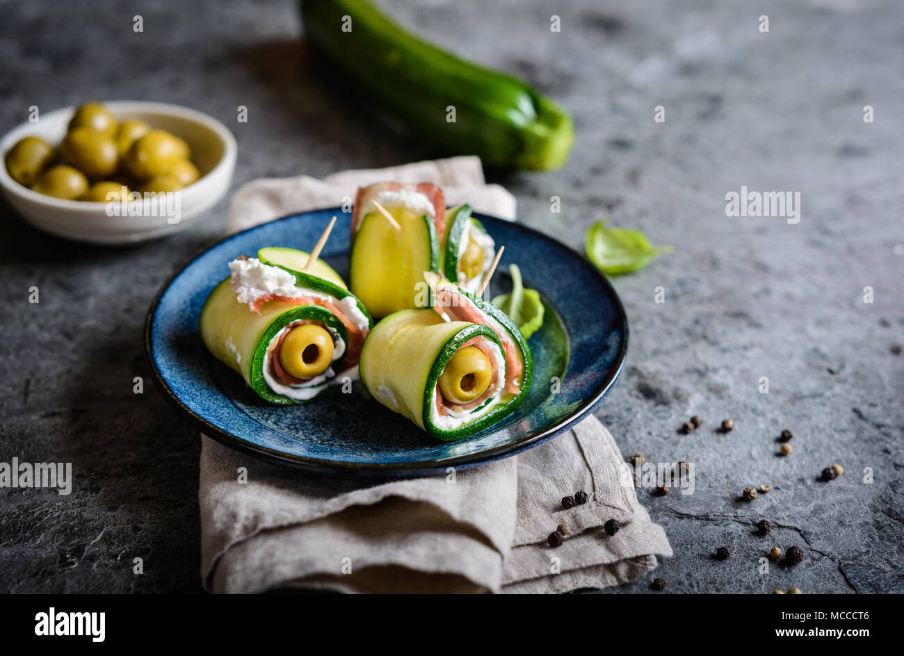 Fried rolled zucchini slices stuffed with bacon, cream cheese and olive Stock Photo
