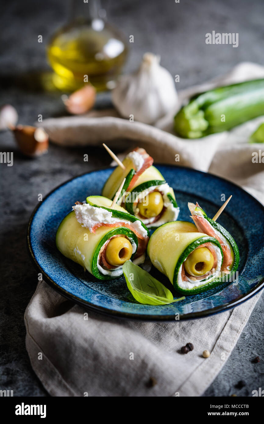 Fried rolled zucchini slices stuffed with bacon, cream cheese and olive Stock Photo