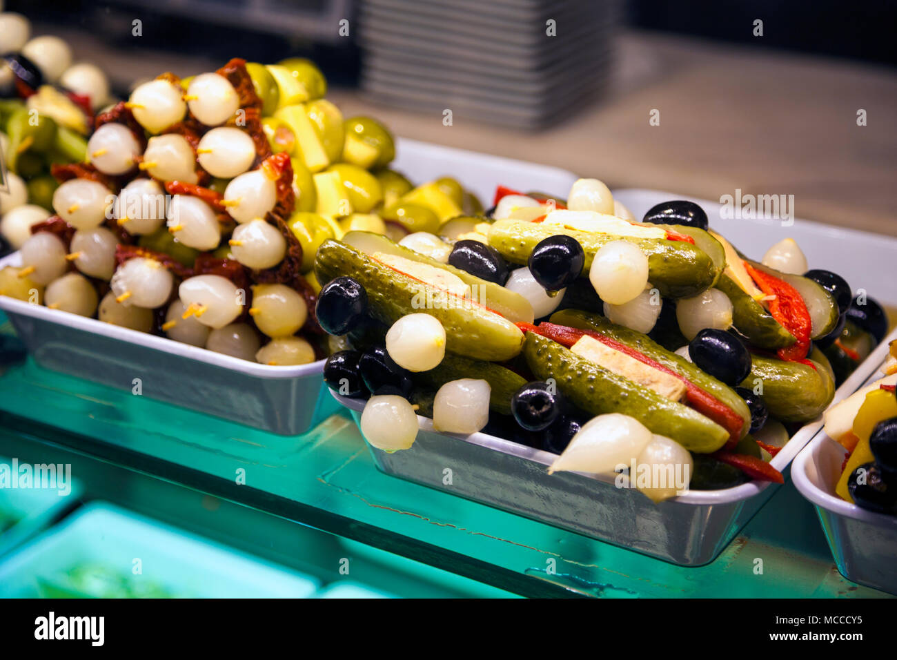 Pickled cucumbers, olives and onions - tapas at Market of San Miguel in Madrid, Spain Stock Photo