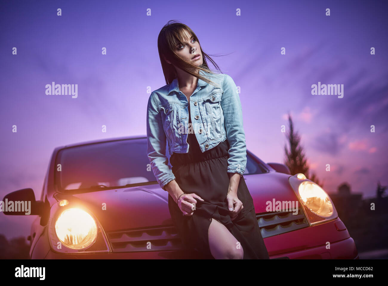 Beautiful girl fashionably stand near car Stock Photo