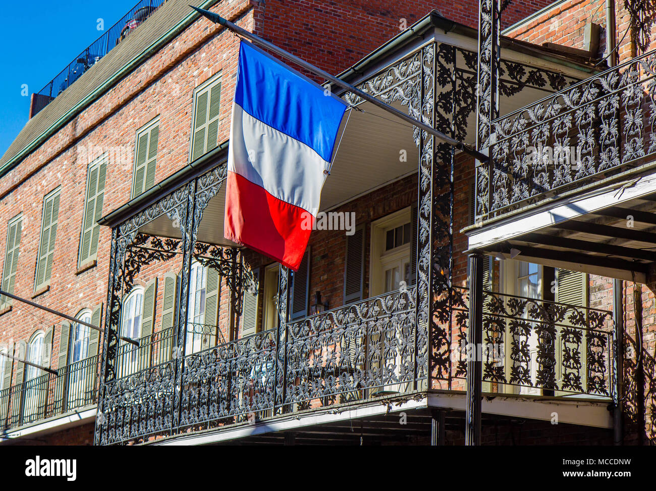 French Flag Hanging From Cast Iron Balcony On A Building In The French Quarter New Orleans Louisisana United States Stock Photo Alamy