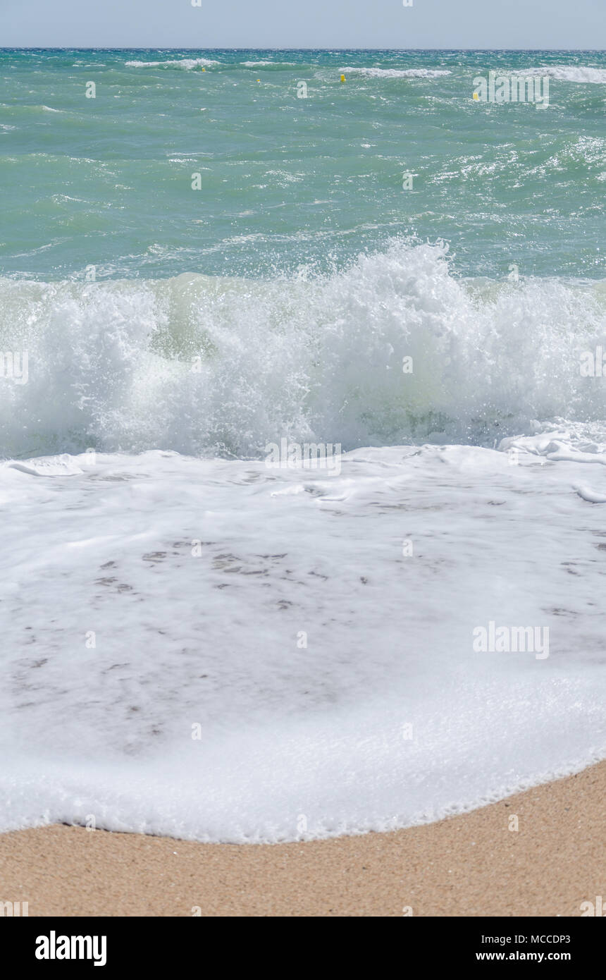 Waves breaking on a beach. Stock Photo