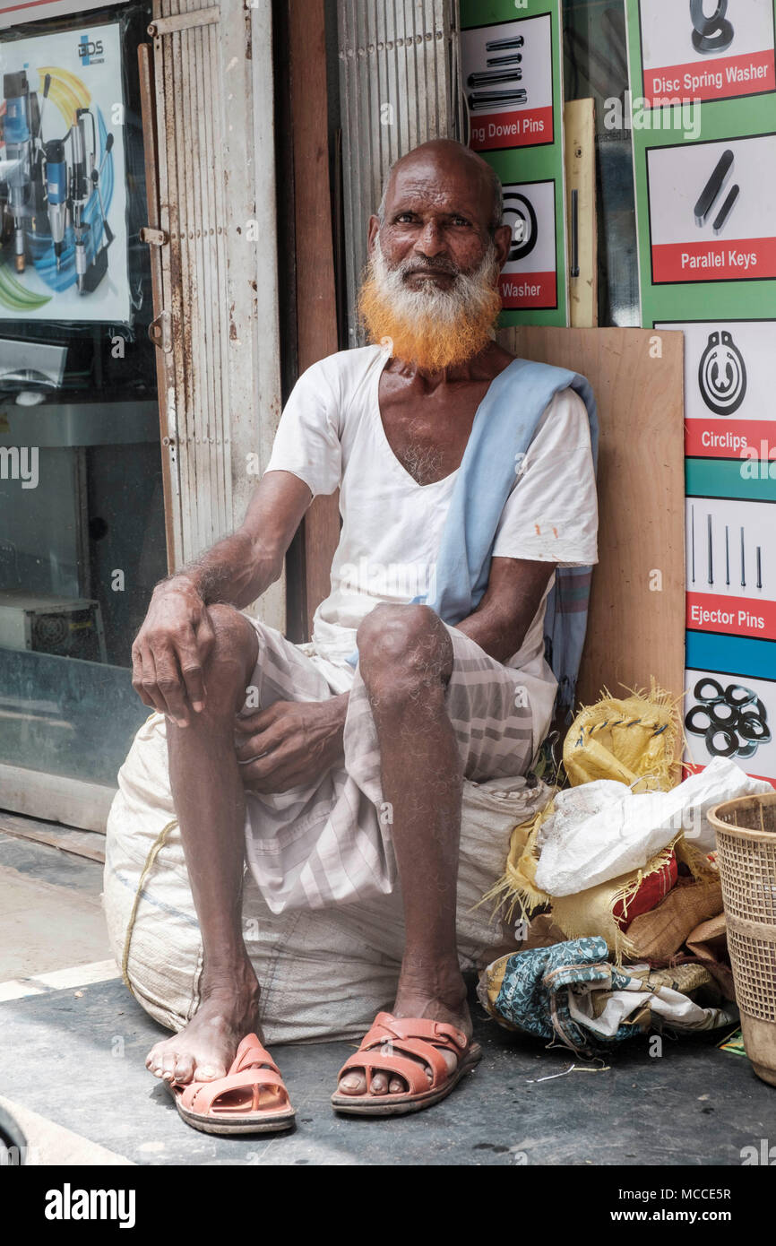 Old man with a henna-dyed beard outside a store on Nagdevi street near Crawford Market in Mumbai Stock Photo