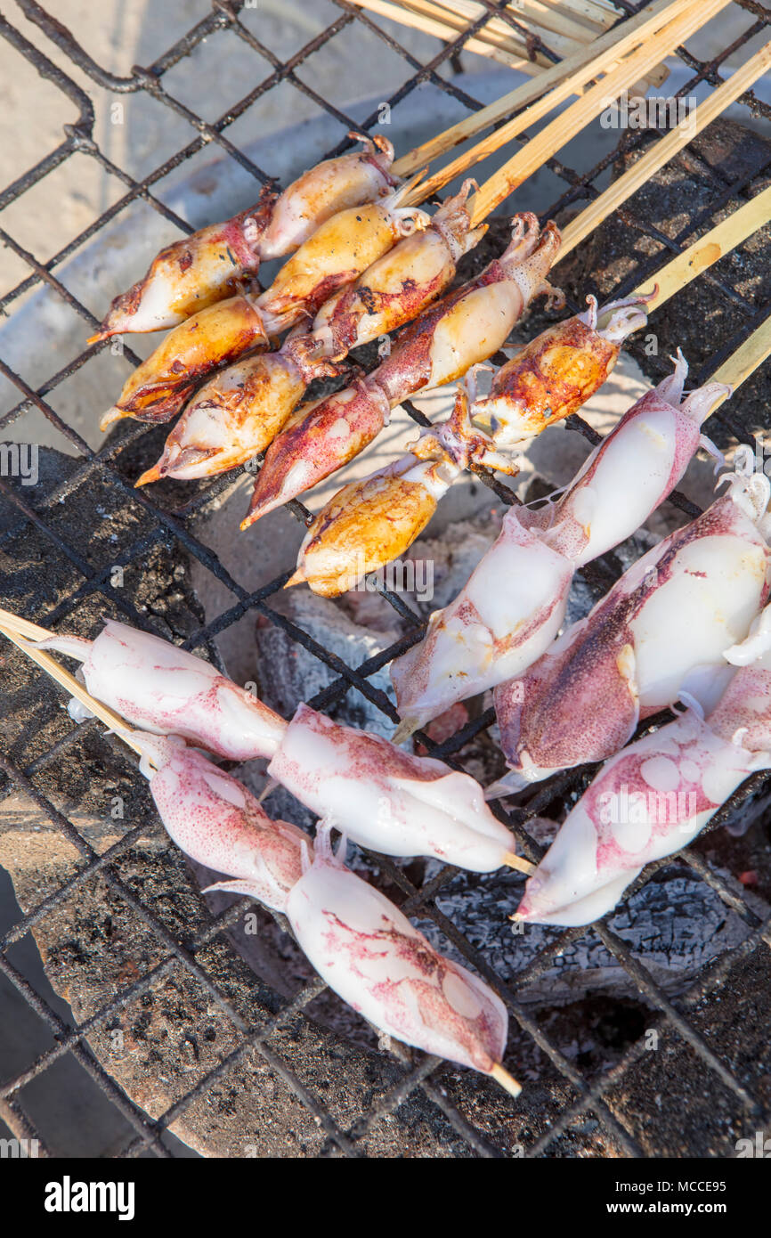 Skewered baby squid for sale at a street food barbecue in Kep province