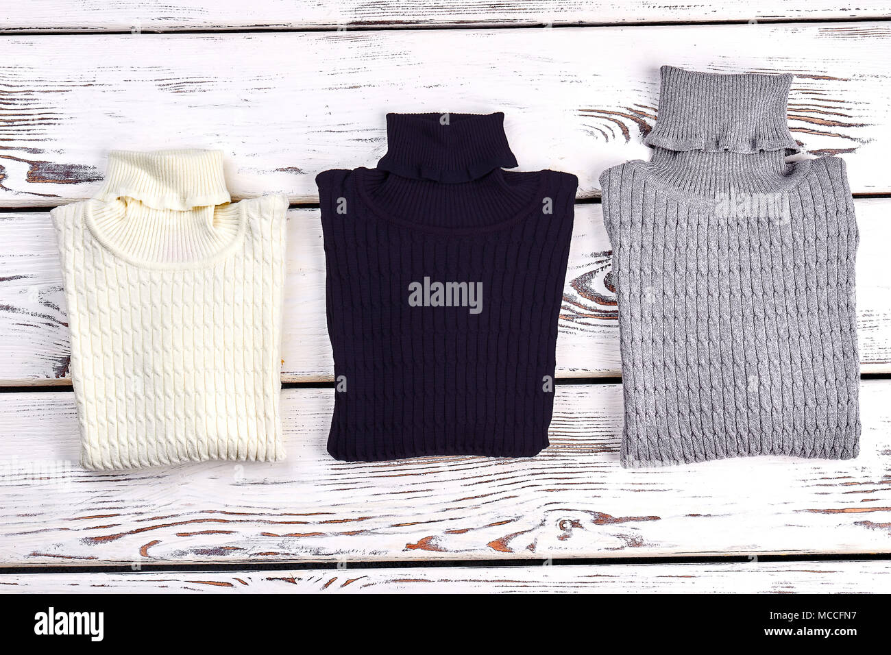 New folded cable turtleneck sweater. Texture design thick knitted sweaters on sale top view. Children winter knitwear Stock Photo Alamy