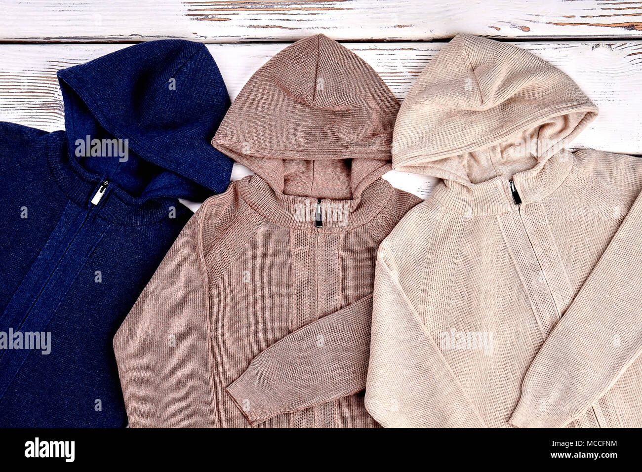 New knitted hooded jackets. Casual knit cardigans with hoodies on sale. Knit fashion sweaters for kids Stock Photo Alamy
