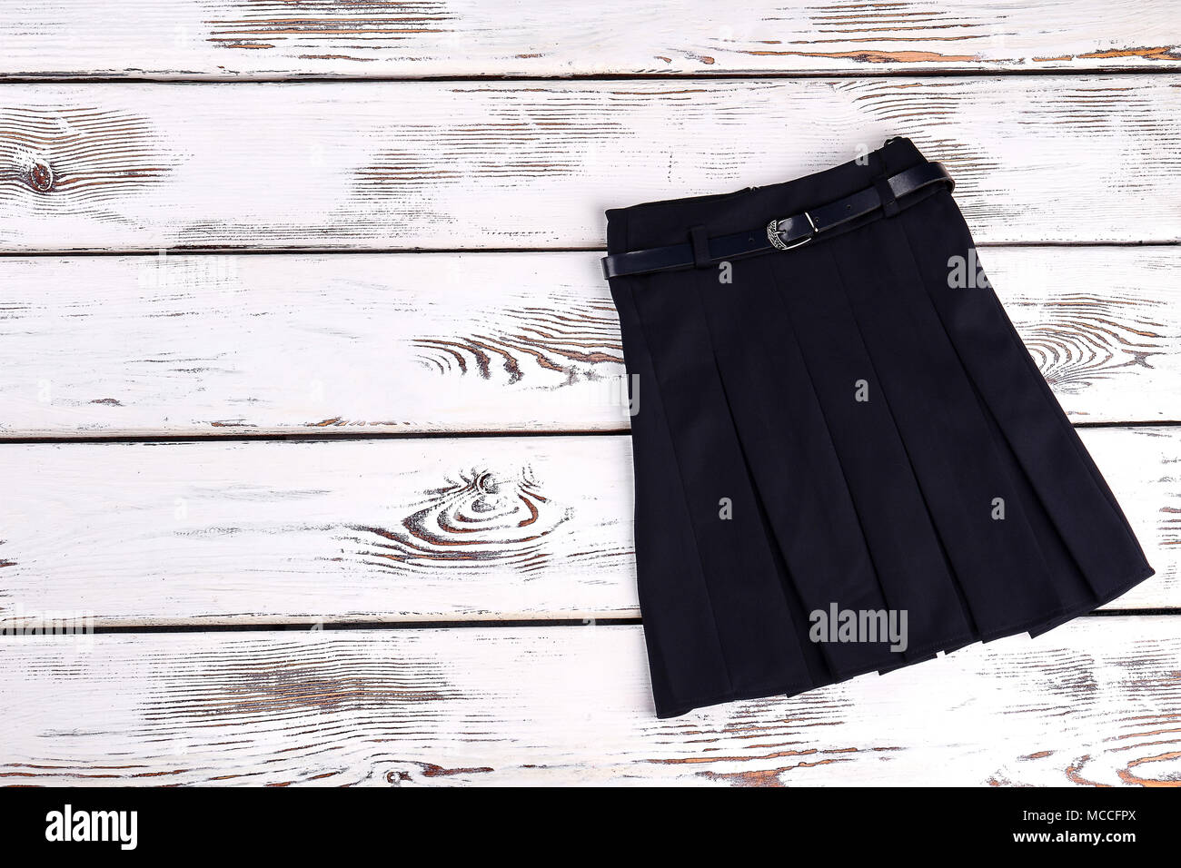 Black belted skirt for school wear. Pleated black uniform skirt on old
