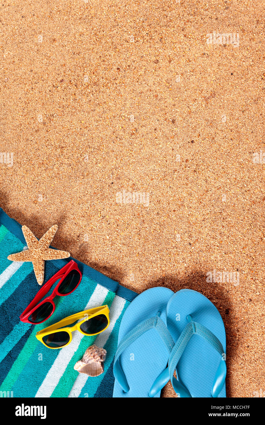 Summer beach background border, flip flops, sand copy space, vertical