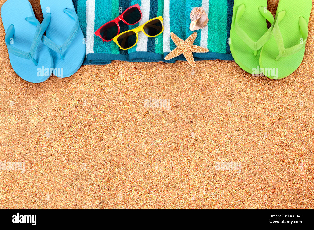 Summer beach background border, flip flops, sand copy space Stock Photo