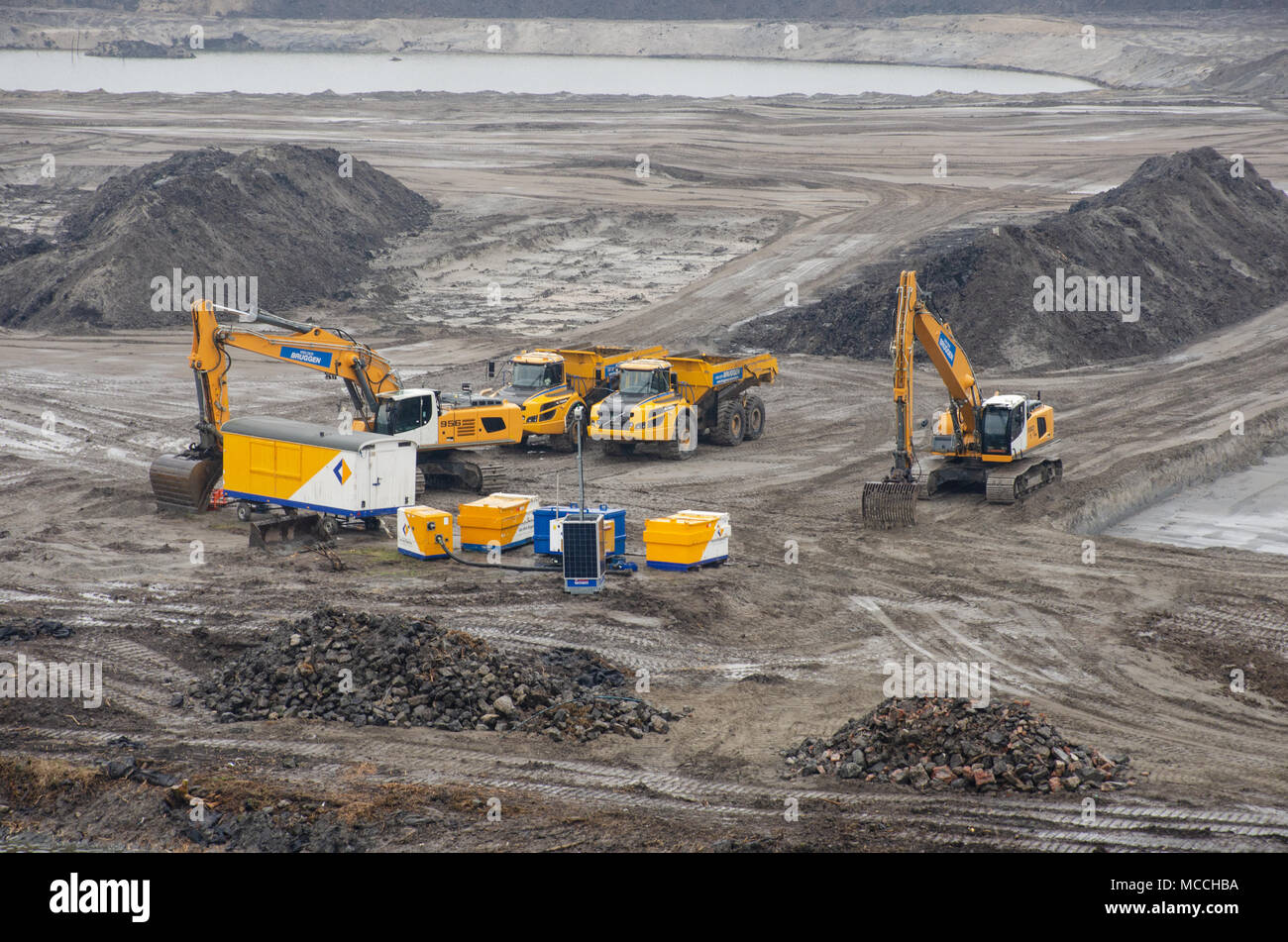 North Sea Canal Amsterdam Netherlands - 1 April 2018: Yellow earth moving equipment on landfill site Stock Photo