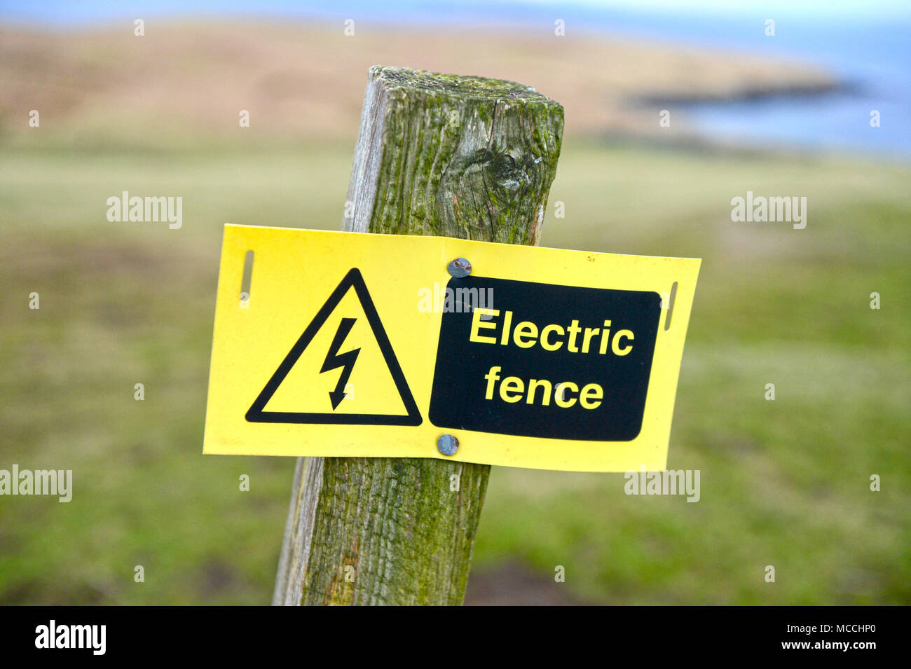 Weathered Danger Electric Fence Sign Stock Photo - Alamy