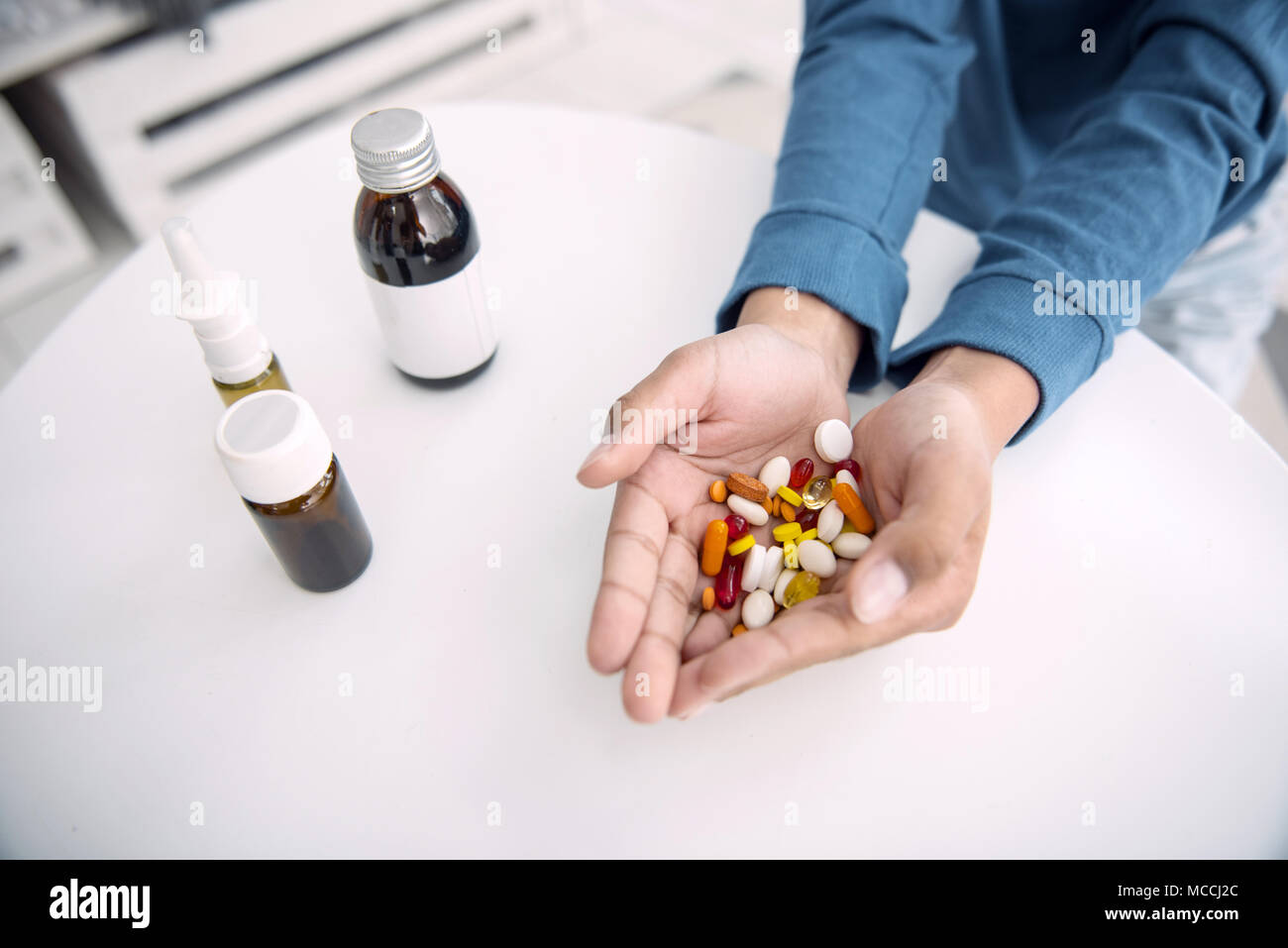 Afro american boys hands grasping pills Stock Photo