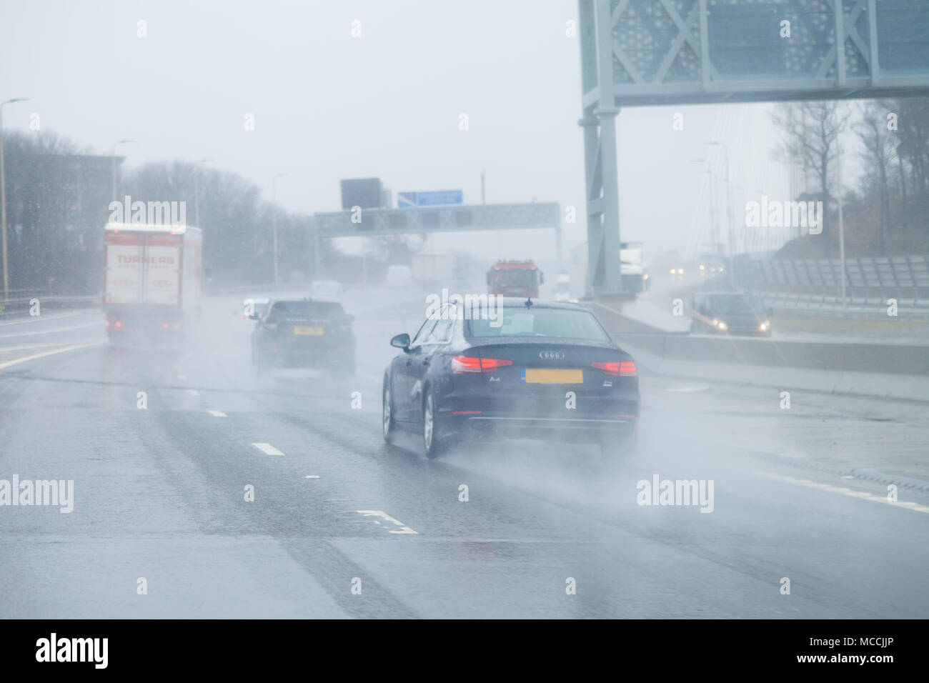 Cars crossing the Queensferry Crossing in very wet driving conditions, Fife, Scotland. Stock Photo