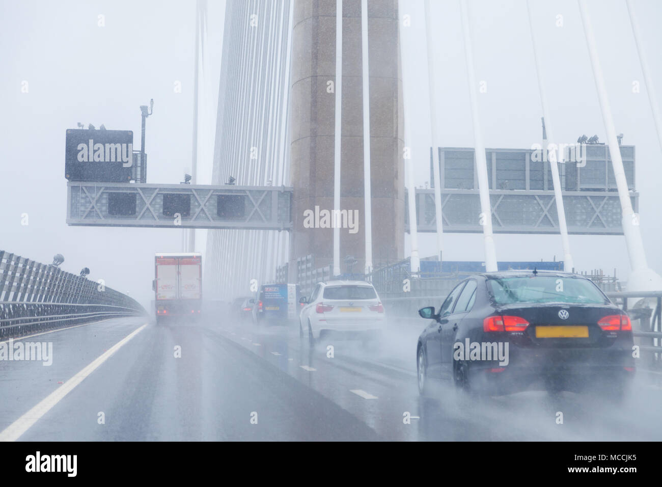 Cars crossing the Queensferry Crossing in very wet driving conditions, Fife, Scotland. Stock Photo