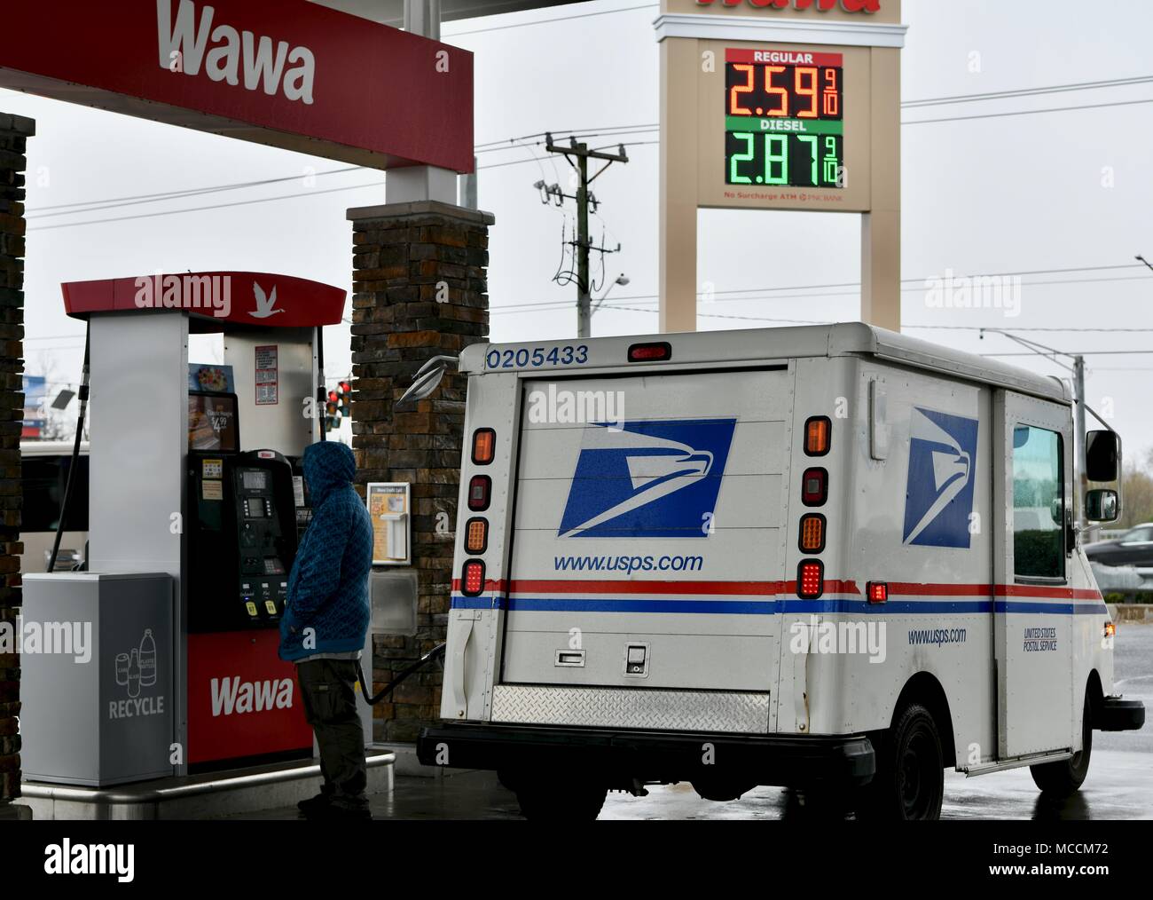 United States Postal Service (USPS) van filling up on gasoline in
