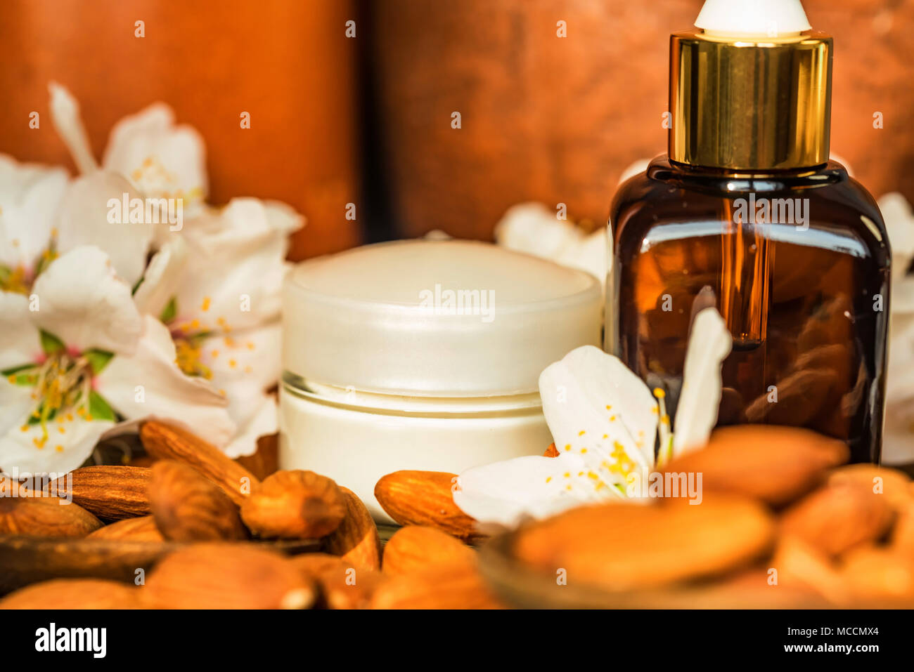 Almonds, oil, face cream and white flowers Stock Photo Alamy