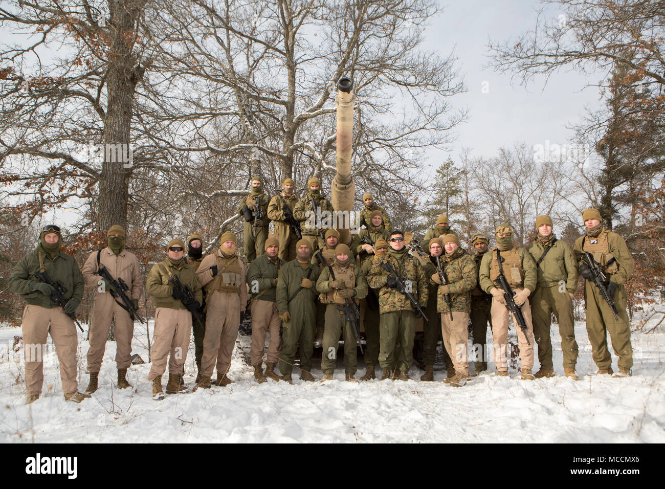 Reserve Marines with Company F, 4th Tank Battalion, 4th Marine Division, pose for a photo on training day one of exercise Winter Break 2018 on Camp Grayling, Michigan, Feb. 7, 2018. Reserve Marines spend two weeks each year building their capabilities at an Annual Training exercise. This year, the Camp Lejeune, North Carolina, based tank company is taking advantage of Camp Grayling’s rugged training areas to test their offensive, defensive and maneuver capabilities in an austere cold weather environment. Stock Photo