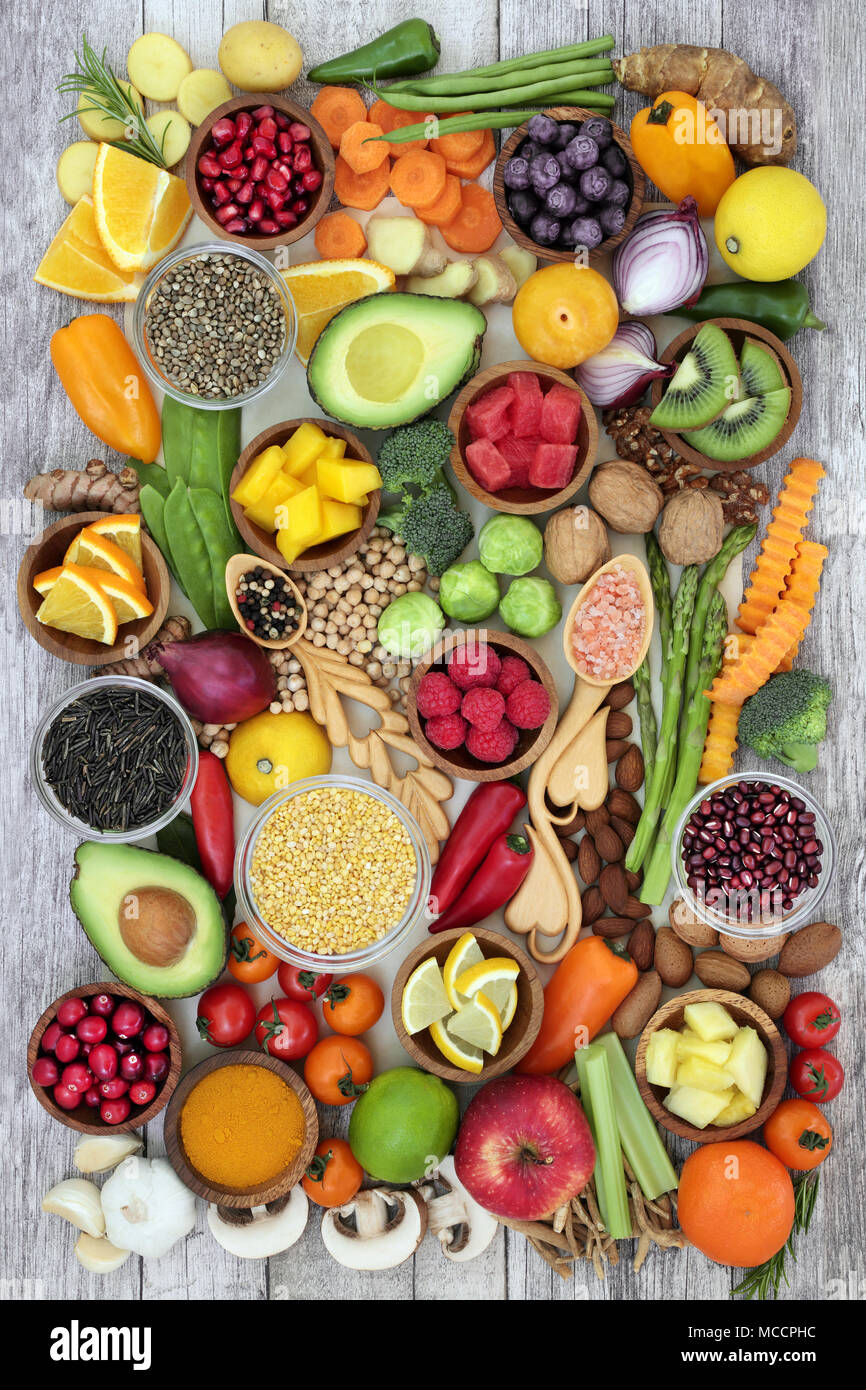 Health food concept with fruit, vegetables, herbs, spice, nuts, seeds