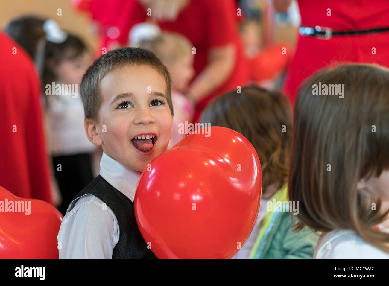 Little boy with a red ball in the form of a heart Stock Photo Alamy