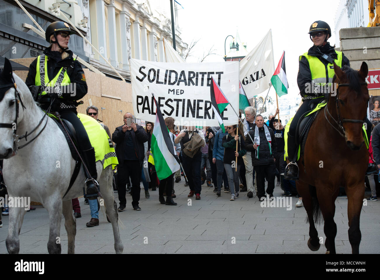 Protesters carry a sign reading 'Solidarity with Palestinians' as they march to Norway’s parliament building to protest Israel's shooting of Palestinians in Gaza. Oslo, April 14, 2018. Stock Photo