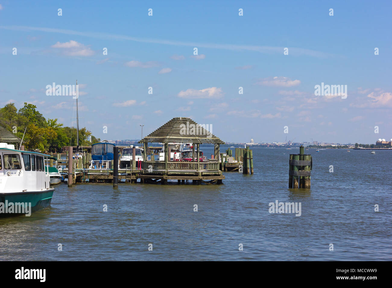 A pier at waterfront of Old Town Alexandria, Virginia, USA. A wooden gazebo and views over the Potomac River with US capital on horizon. Stock Photo