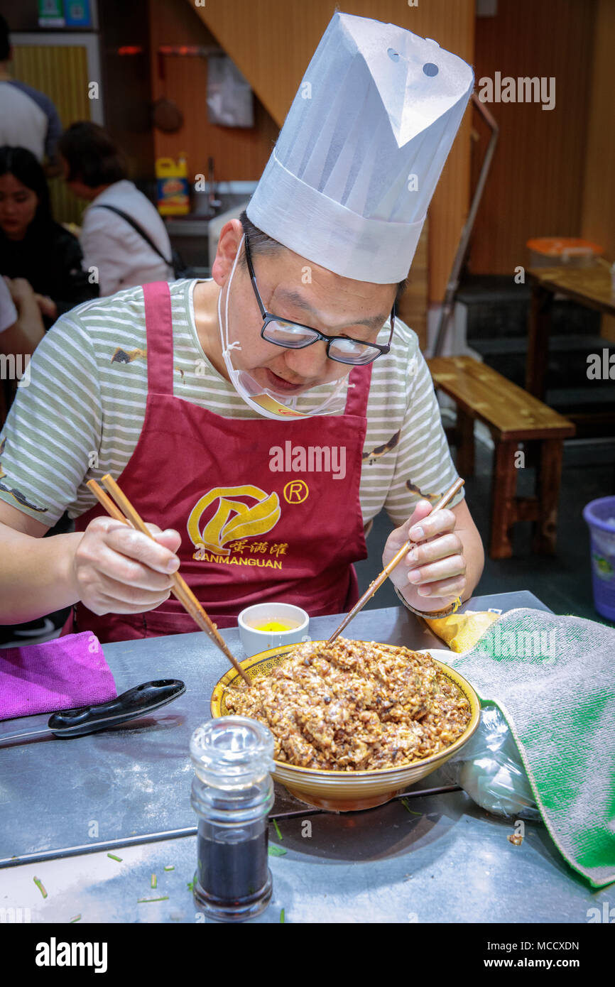 A chief is preparing Chinese food, Xiamen, Fujian, China Stock Photo