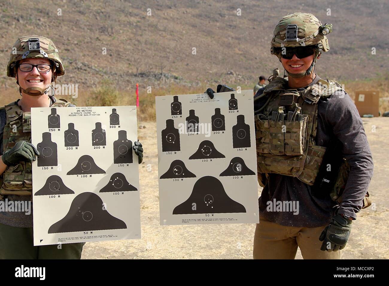 Soldiers of Task Force Darby and 1st Battalion, 87 Infantry Regiment, 1st Brigade Combat Team, 10th Mountain Division, qualify on a weapon’s range in Garoua, Cameroon Feb. 8, 2018. Pfc. Hitchcock and Pfc. Ho show their range cards. TF Darby serve members are serving in a support role for the Cameroonian Military’s fight against the violent extremist organization Boko Haram. Stock Photo