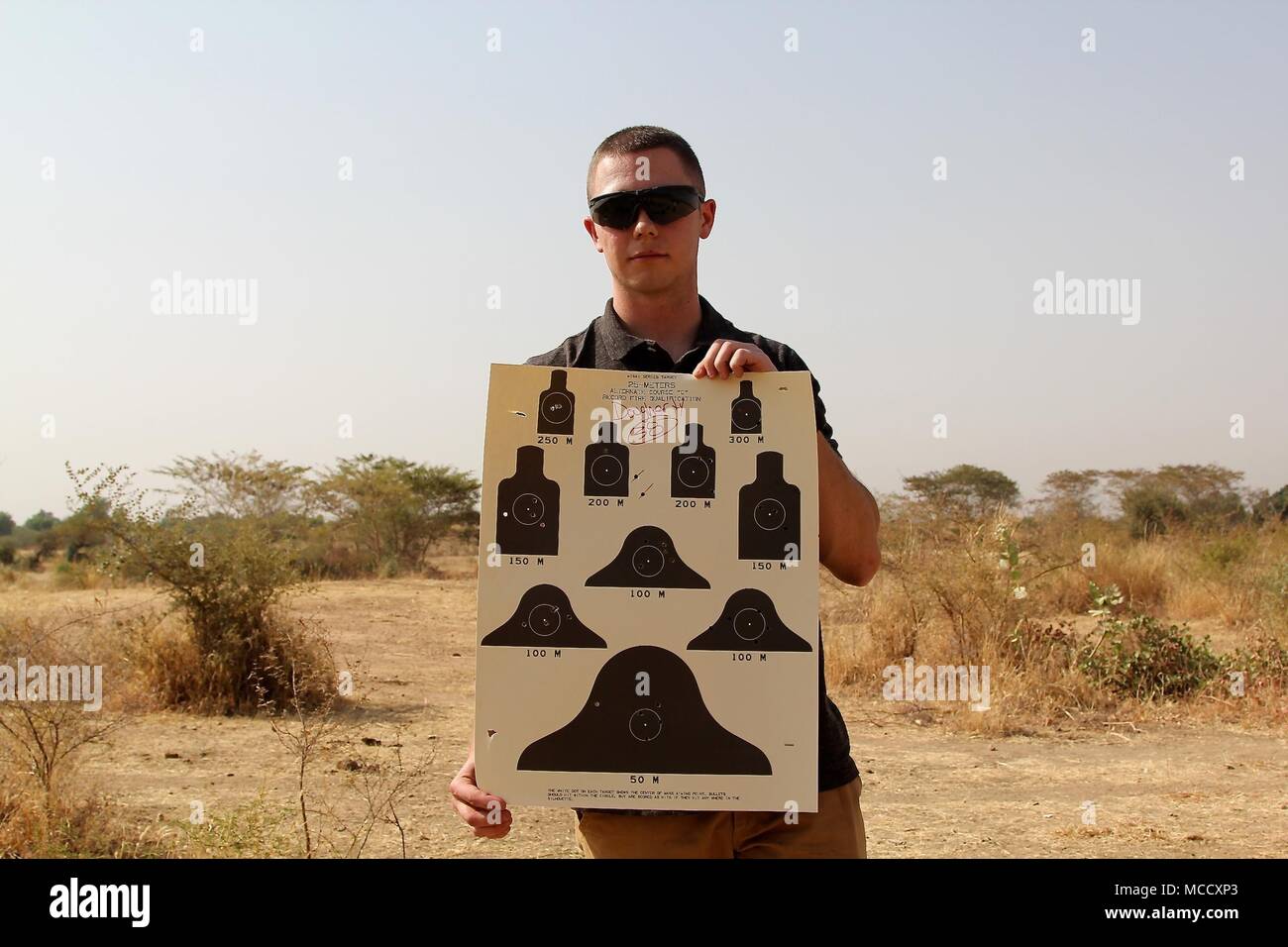 Soldiers of Task Force Darby and 1st Battalion, 87 Infantry Regiment, 1st Brigade Combat Team, 10th Mountain Division, qualify on a weapon’s range in Garoua, Cameroon Feb. 8, 2018. Pfc. Daugherty shows his M4 range card. TF Darby serve members are serving in a support role for the Cameroonian Military’s fight against the violent extremist organization Boko Haram. Stock Photo