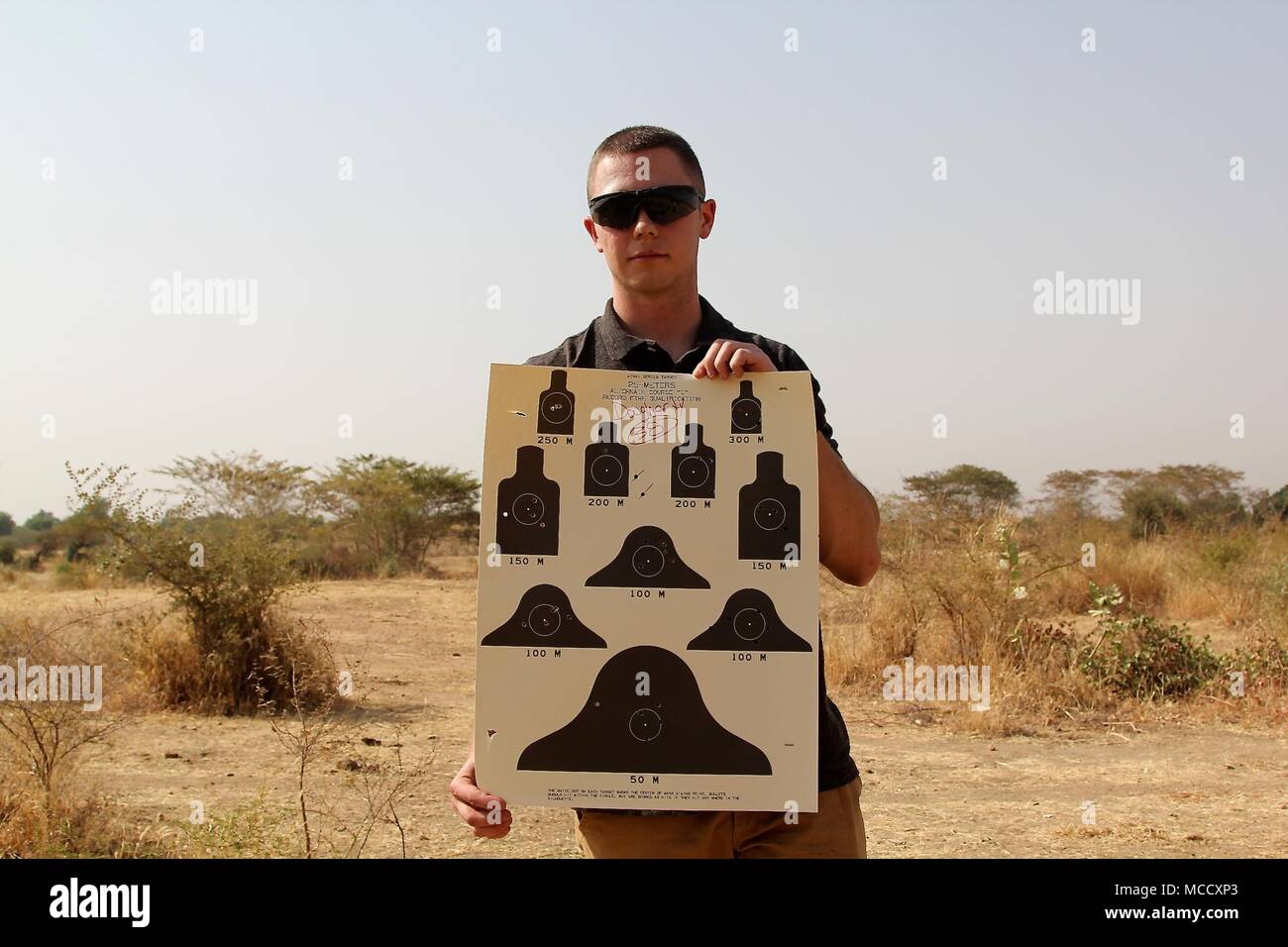 Soldiers of Task Force Darby and 1st Battalion, 87 Infantry Regiment, 1st Brigade Combat Team, 10th Mountain Division, qualify on a weapon’s range in Garoua, Cameroon Feb. 8, 2018. Pfc. Daugherty shows his M4 range card.  TF Darby serve members are serving in a support role for the Cameroonian Military’s fight against the violent extremist organization Boko Haram. Stock Photo