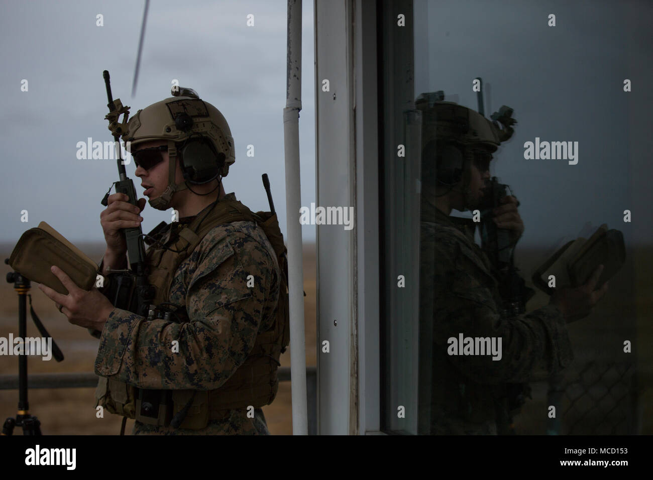 Captain Michael Valdez, an air officer with 2nd Air Naval Gunfire Liaison Company, radios to aircraft pilots during close air-support drills at an aircraft attack range on Piney Island, North Carolina, Feb. 7, 2018. The Marines practiced making flight and attack plans for the pilots depending on specific situations. (U.S. Marine Corps photo by Lance Cpl. Ashley McLaughlin) Stock Photo
