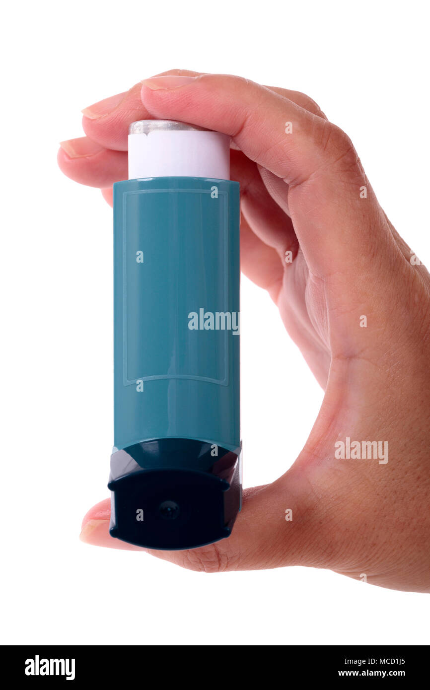 Hand holding asthma inhaler isolated on white background, vertical Stock Photo