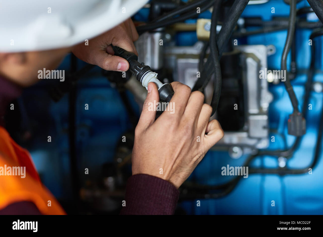 Young Technician Wrapped up in Work Stock Photo