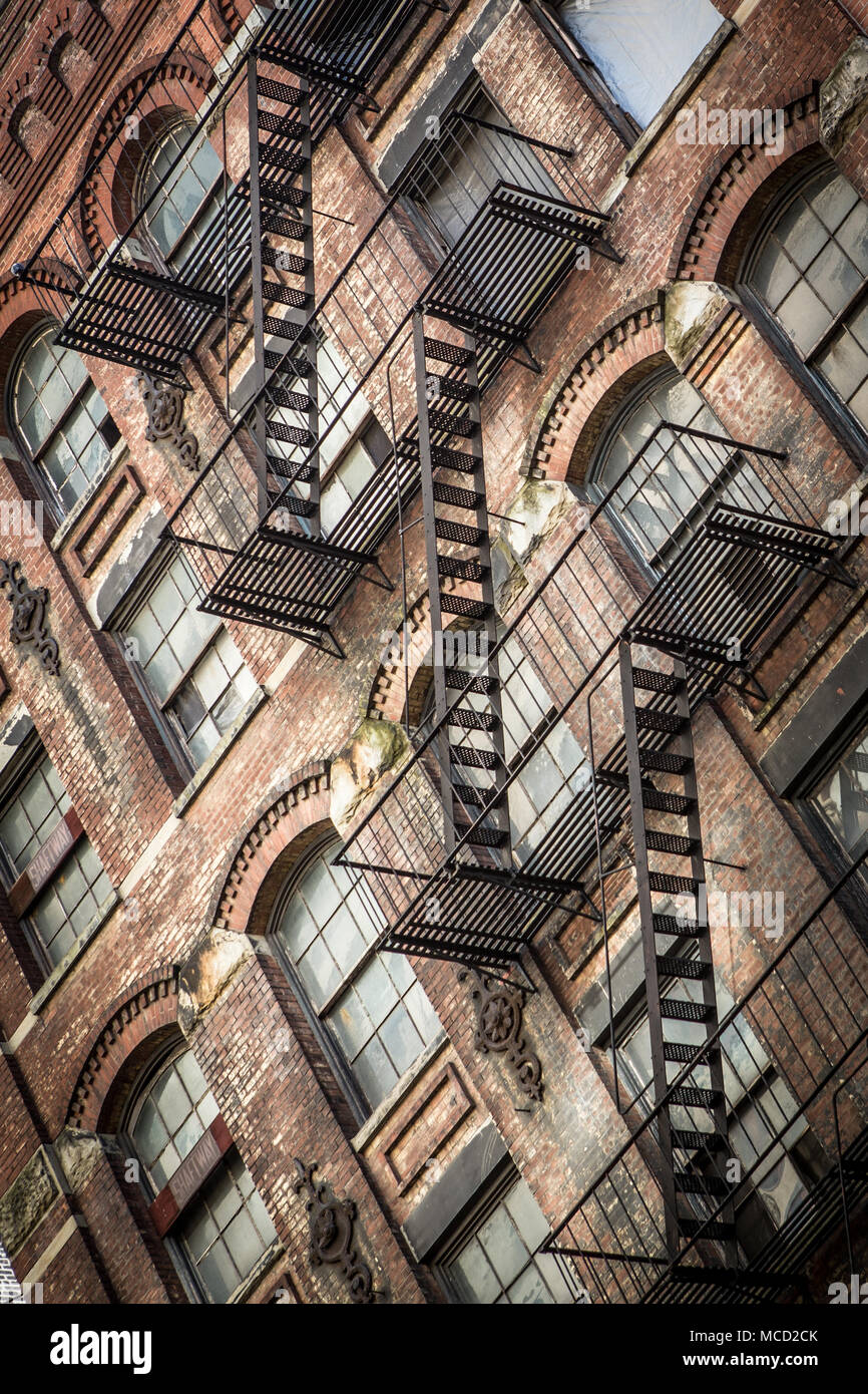 Fire escapes on a brown stone apartment building in Manhattan, New York City. Stock Photo