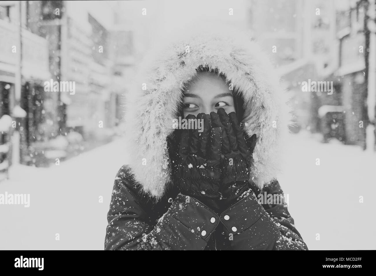 Young asian tourist woman in Winter, Sapporo - Japan. Black and white. Stock Photo