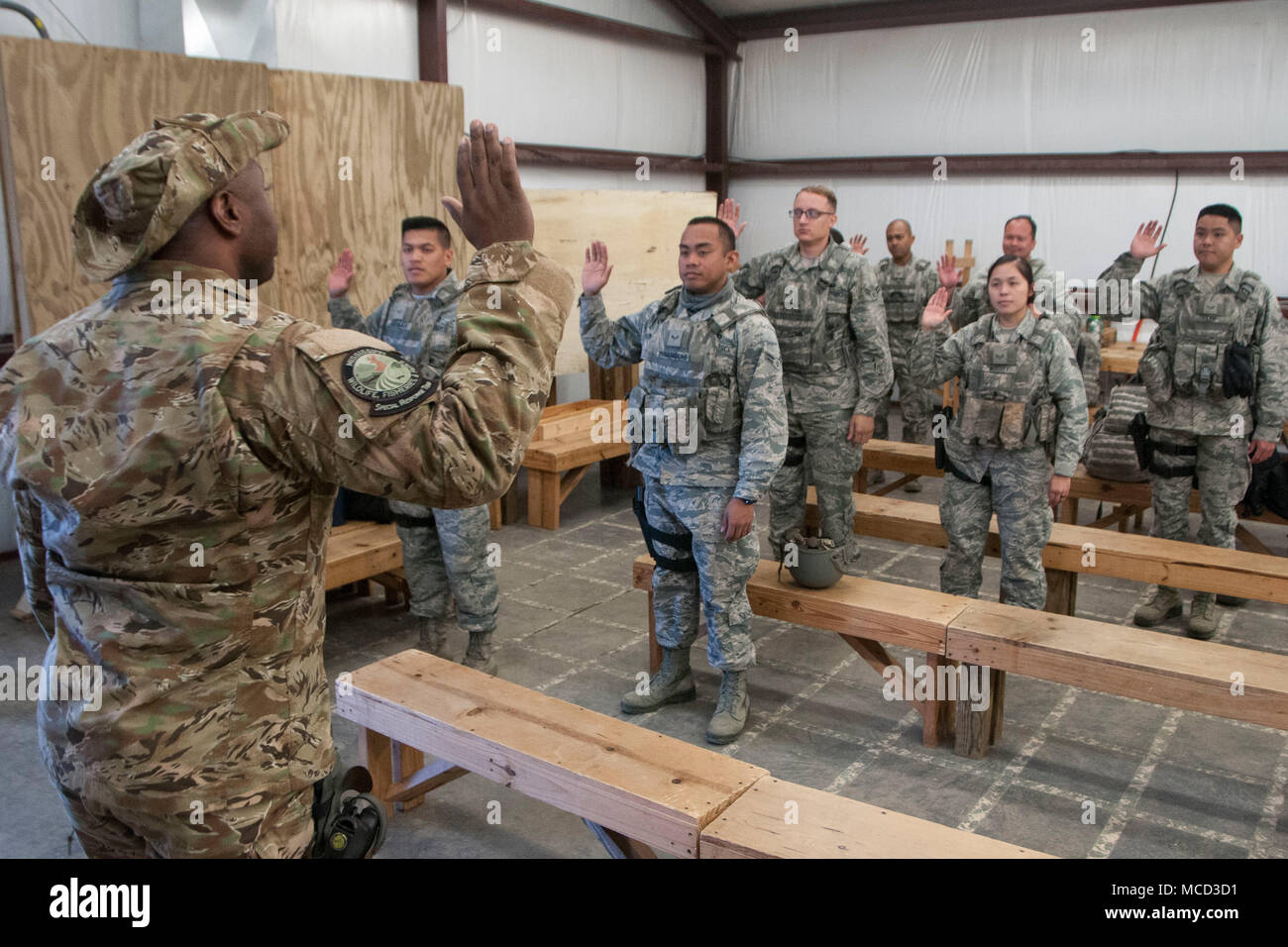 Airmen from the 154th Security Forces Squadron recite an oath as they are unofficially deputized under the authority of police Capt. Dale Bell, Mississippi Department of Wildlife, Fisheries and Parks Special Response Team chief, Feb. 13, 2018, at Camp Shelby, Mississippi. The defenders traveled from their home unit at Joint Base Pearl Harbor-Hickam, Hawaii, to serve as a backup-support for the MWFP SRT during exercise Patriot South. (U.S. Air National Guard photo by Senior Airman John Linzmeier) Stock Photo