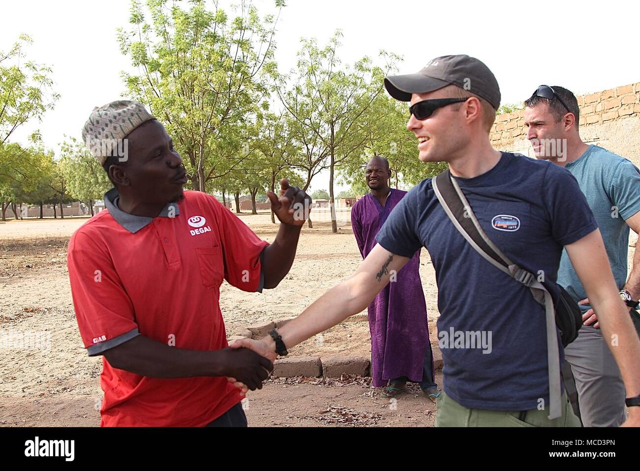 Task Force Darby soldiers of Civil Affairs Team 4032 assist village leaders as they built a roof for a school in Garoua, Cameroon near Contingency Location Garoua Feb. 10, 2018. Stock Photo