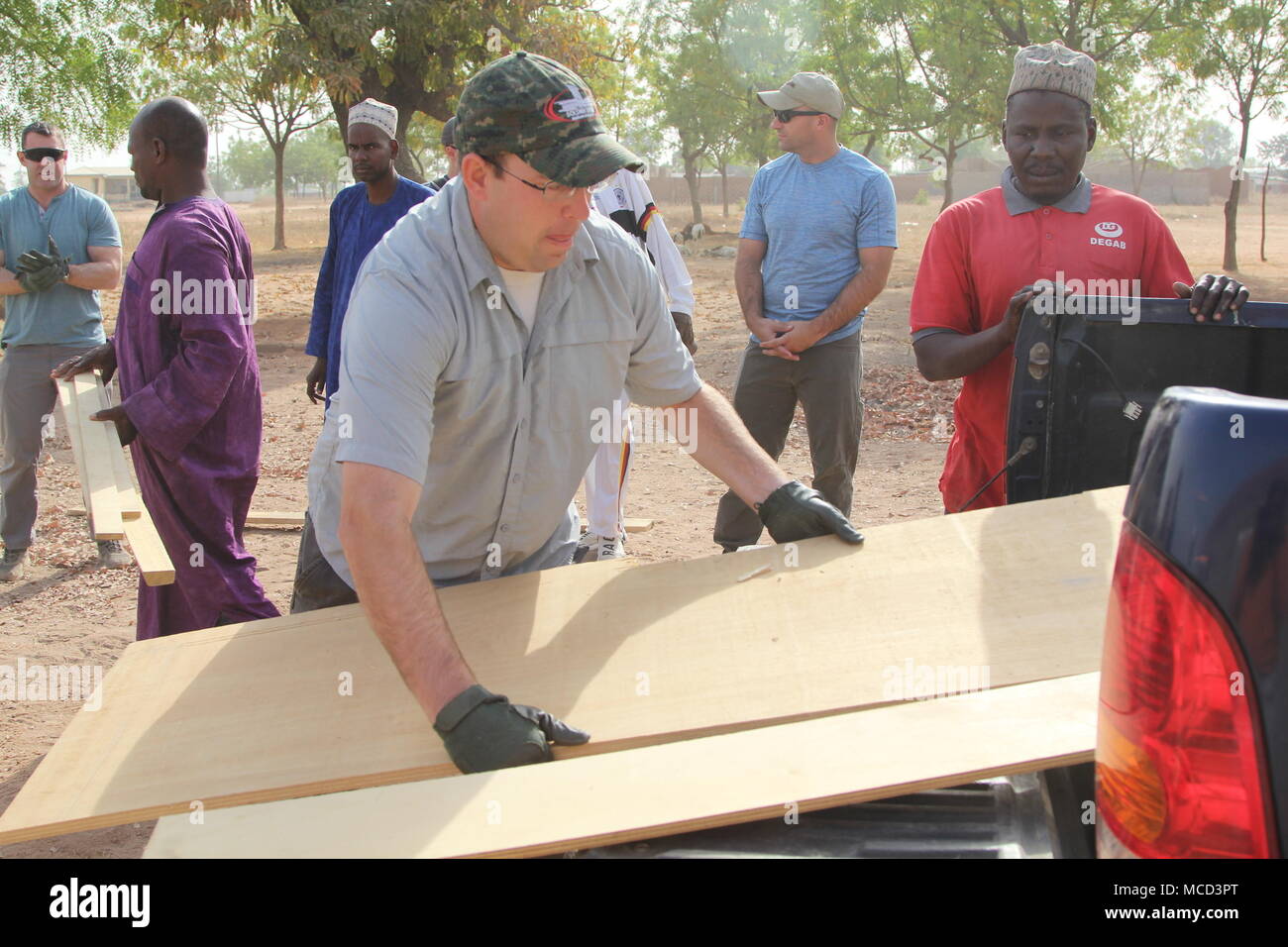 Task Force Darby soldiers of Civil Affairs Team 4032 assist village leaders as they built a roof for a school in Garoua, Cameroon near Contingency Location Garoua Feb. 10, 2018. Stock Photo