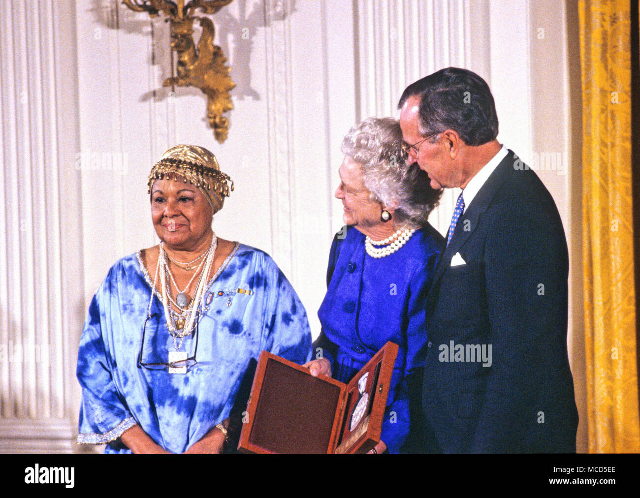 United States President George H.W. Bush and first lady Barbara Bush present the National Medal of Arts to American dancer and choreographer Katherine Dunham during a ceremony in the East Room of the White House in Washington, DC on November 19, 1989. Credit: Ron Sachs/CNP /MediaPunch Stock Photo