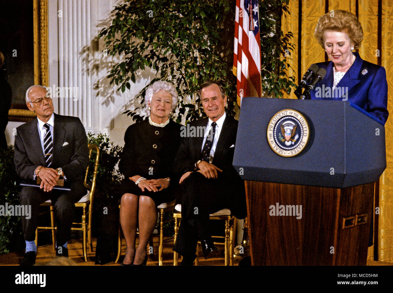 United States President George H.W. Bush awards the Presidential Medal of Freedom, the highest civilian honor awarded by the U.S., to former Prime Minister Margaret Thatcher of Great Britain in the East Room of the White House in Washington, DC on March 7, 1991. From left to right: Denis Thatcher; first lady Barbara Bush, President Bush; Prime Minister Thatcher.Credit: Howard L. Sachs/CNP /MediaPunch Stock Photo