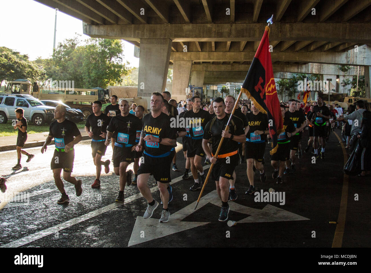 Lt. Col. Travis Dolan, commander, Headquarters and Headquarters Battalion, 25th Infantry Division, leads 'Phoenix Battalion' Soldiers on the 8.15-mile Great Aloha Run Feb. 19 in downtown Honolulu. The annual foot race has raised more than $12 million for 150 non-profit health and human service organizations and community groups throughout Hawaii over the past 34 years, according to Carole Kai Charities, Inc. (Photo by 1st Lt. Ryan DeBooy, 2nd Brigade Combat Team, 25th Inf. Div.) Stock Photo