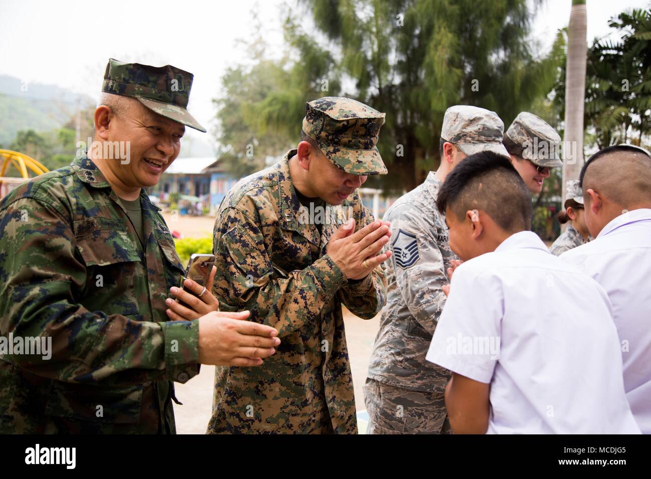 U.S. Navy Lt. Aroon Seeda bows to show thankfulness towards students during Exercise Cobra Gold 2018 at Pong Ka Sang School in Nakhon Ratchasima, Kingdom of Thailand, Feb. 20, 2018. Chaplain Seeda was Born and raised in Pluak Daeng, Rayong province, Kingdom of Thailand as a Buddhist monk and immigrated to the United States in 2001 before joining the Navy Reserve in 2008. Humanitarian civic assistance projects conducted during the exercise support the needs and humanitarian interests of the Thai people. Cobra Gold 18 is an annual exercise conducted in the Kingdom of Thailand and runs from Feb.  Stock Photo