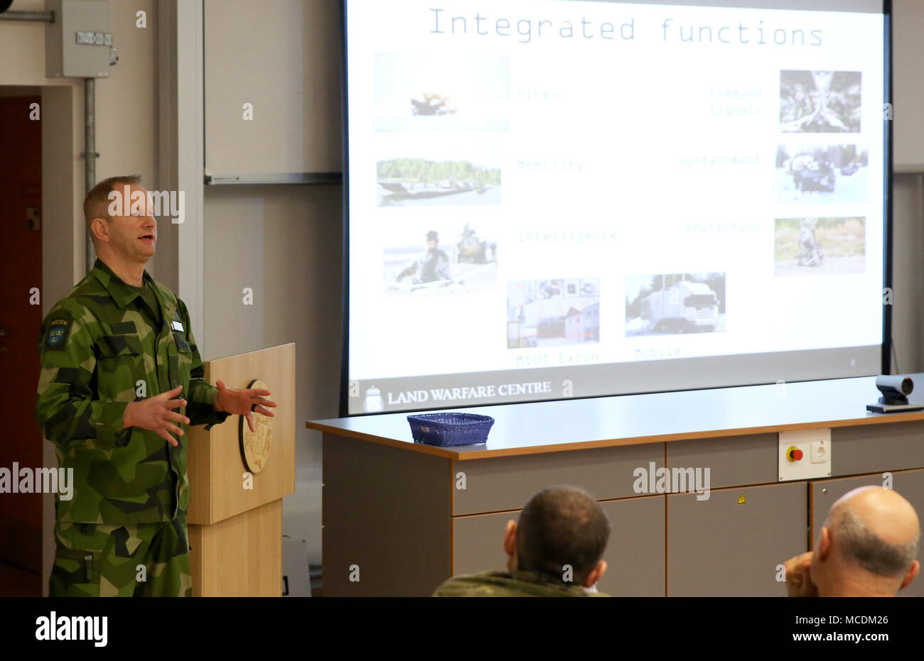 Swedish Army Lt. Col. Joakin Karlquist addresses the group during the first ever 7th Army Training Command's Conference of European Training Centers at the Joint Multinational Readiness Center, Hohenfels, Germany, Feb. 15, 2018. The three-day conference consisted of approximately 65 senior military leaders from 27 NATO and Partner Nation countries. (U.S. Army photo by Staff Sgt. David Overson) Stock Photo