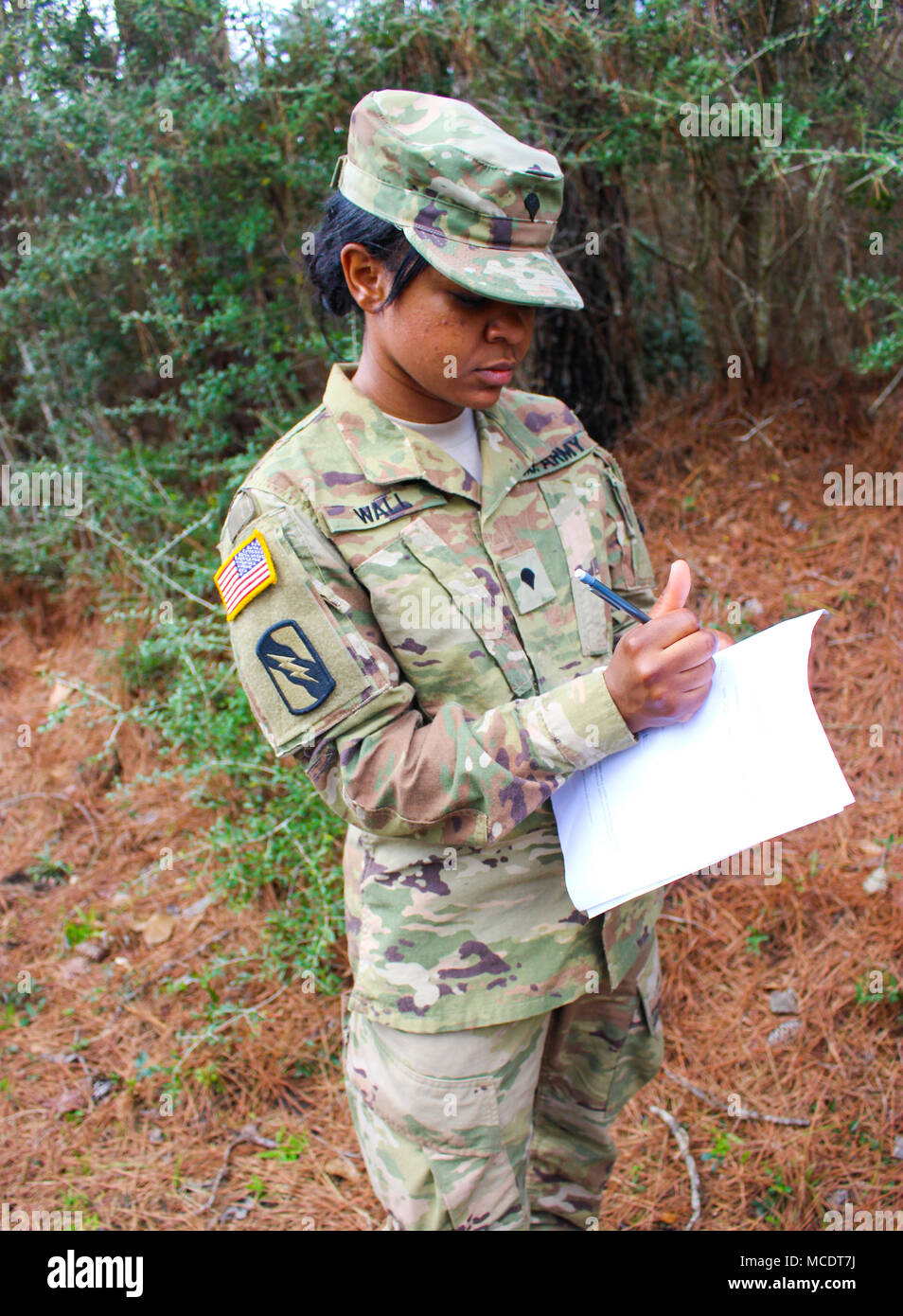 Spc. Chimere Wall, a unit supply specialist with Headquarters Company 155th Armored Brigade Combat Team, participates in a land navigation exercise at Camp Shelby Joint Forces Training Center, Feb. 21, 2018. The 155th ABCT is preparing for an upcoming deployment to the Middle East in support of Operation Spartan Shield. (Mississippi National Guard photo by Sgt. Brittany Johnson) Stock Photo