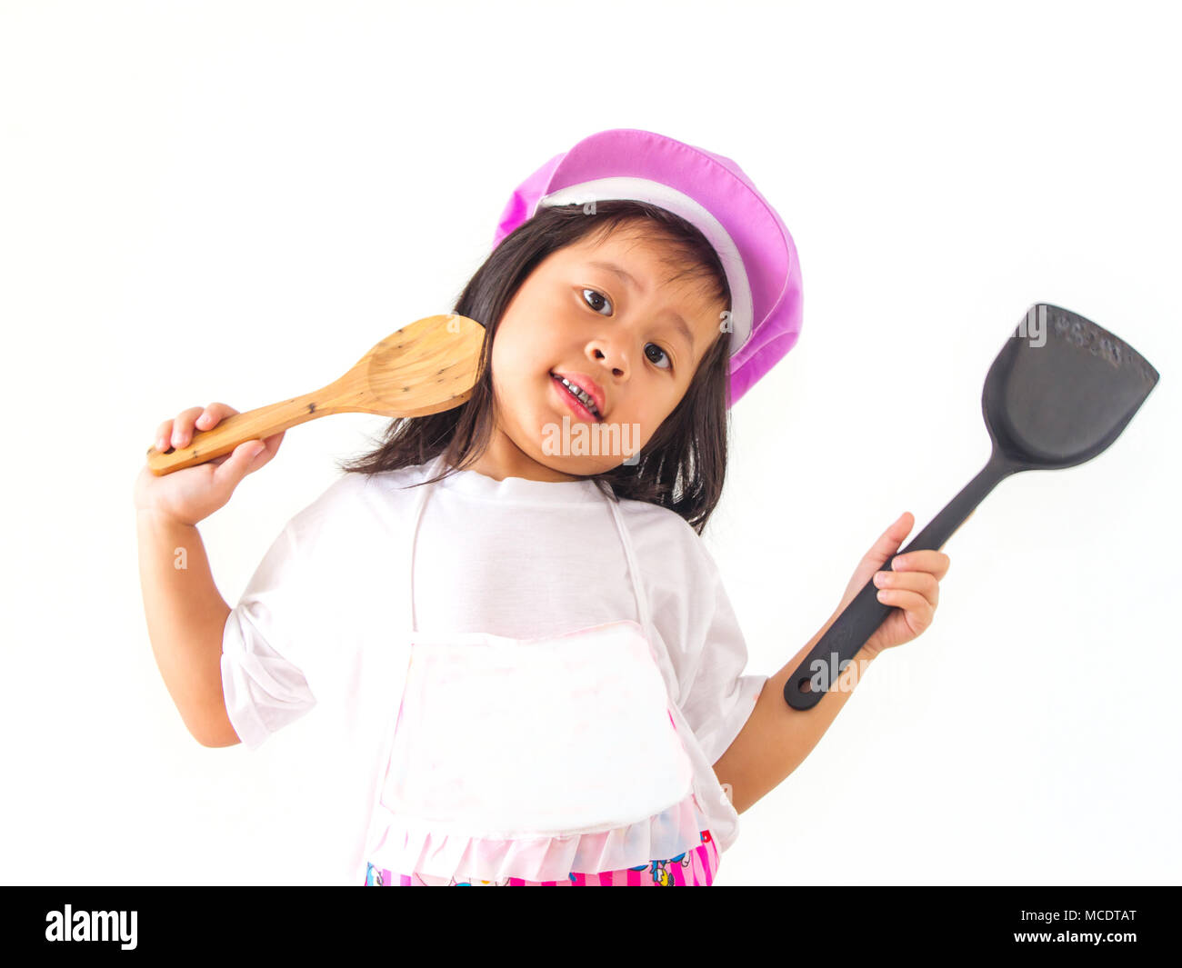 little girl cook holding a ladle on white background. Stock Photo