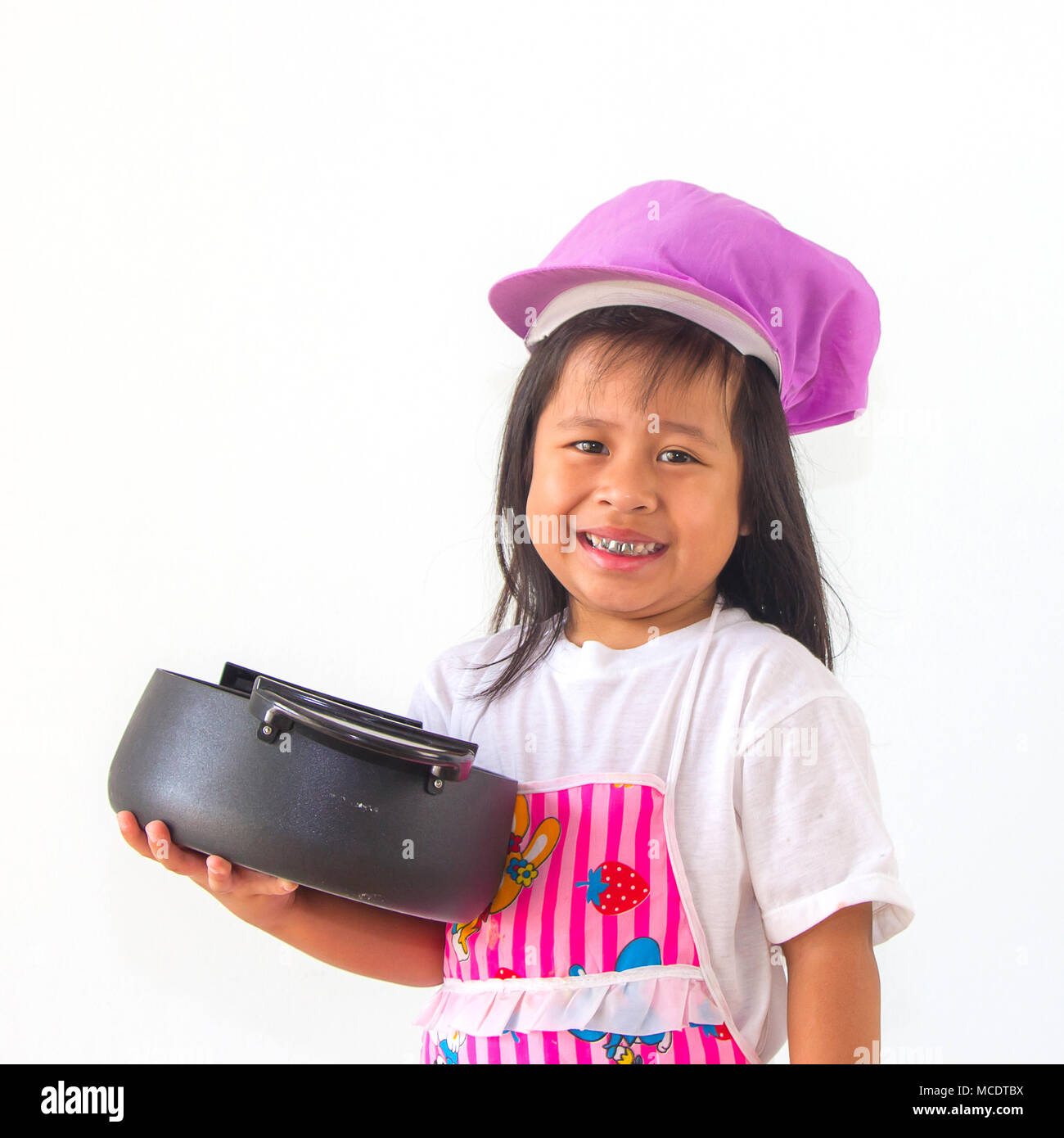 little girl cook holding a pot on white background. Stock Photo